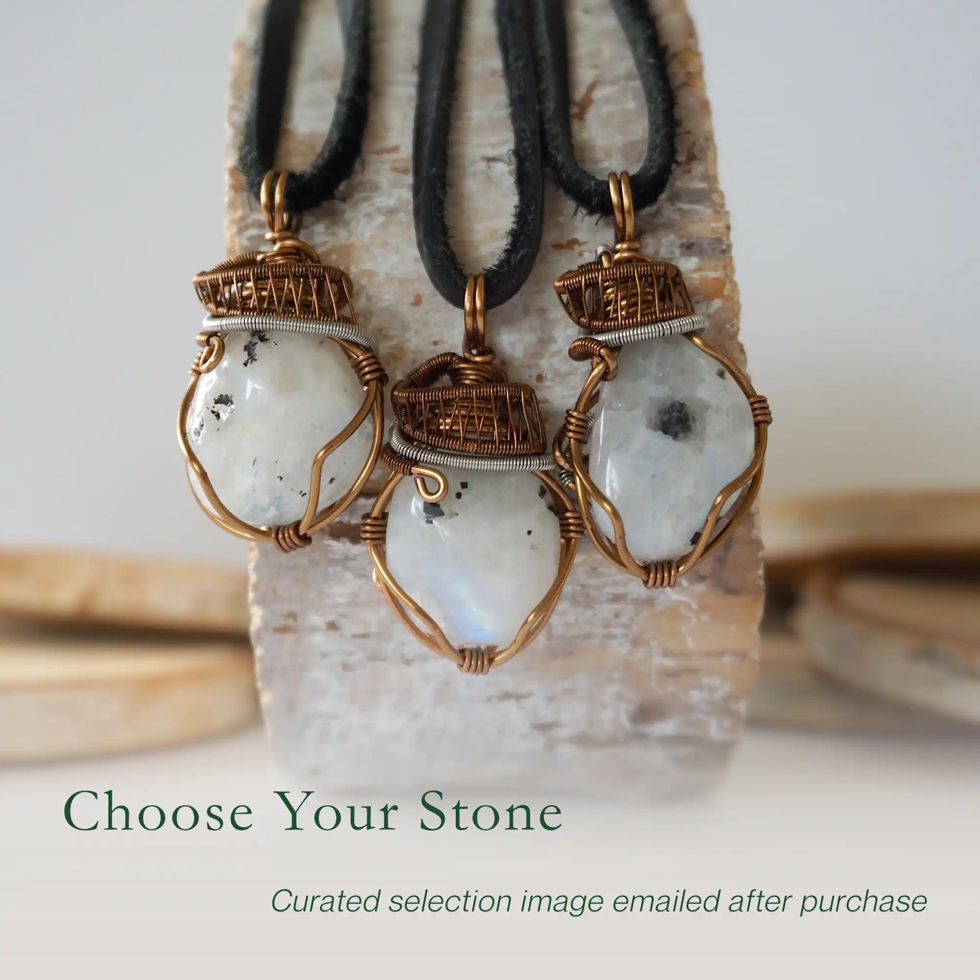 Three rainbow moonstone pendants showing natural variation in size shape and colour in handmade artisan jewelry