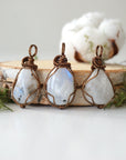 Three natural rainbow moonstone pendants showing variation in size, shape and colour shade in handmade wire wrapped jewelry
