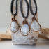 Three natural rainbow moonstone pendants showing variation in size, shape and colour shade in handmade wire wrapped jewelry