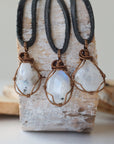 Three natural rainbow moonstone pendants showing variation in size, shape and colour shade in handmade wire wrapped jewelry