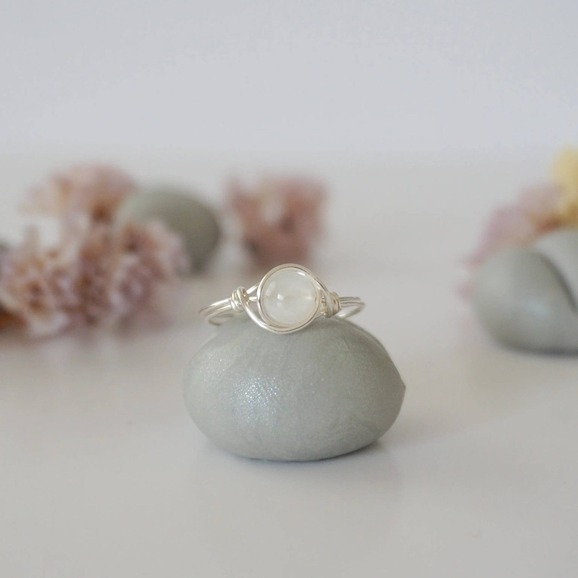 Front close-up of minimalist rainbow moonstone bead ring in sterling silver wire wrap, June birthstone ring for women.