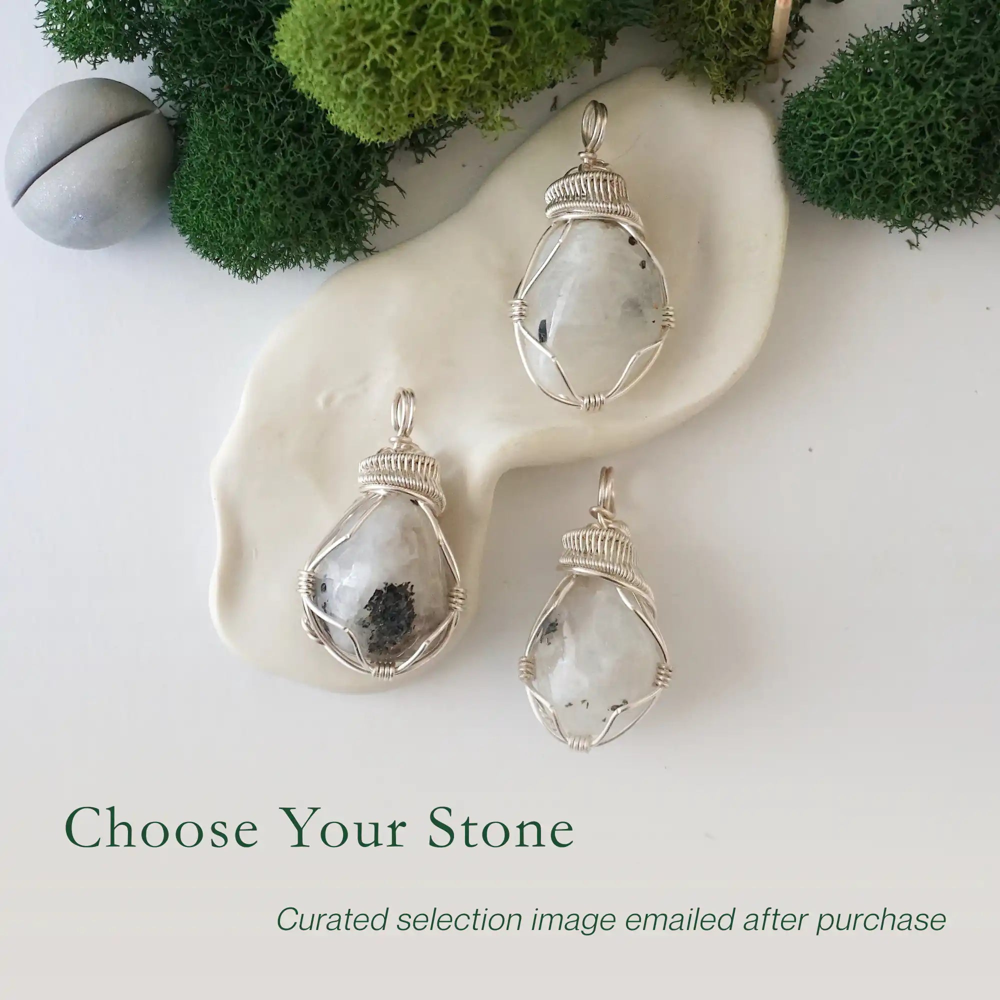 Three rainbow moonstone pendants showing natural variation in size shape and colour in handmade artisan jewelry