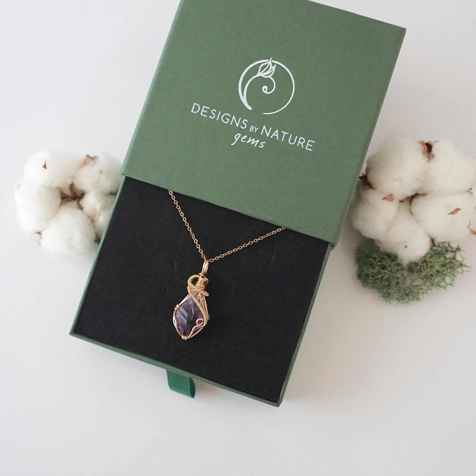 Raw amethyst necklace in 14k gold filled displayed in branded Designs by Nature Gems jewelry box. Artisan February birthstone gift for women.