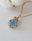 Raw aquamarine necklace in 14k gold filled laying flat. Handcrafted March birthstone jewelry for women by Designs by Nature Gems.