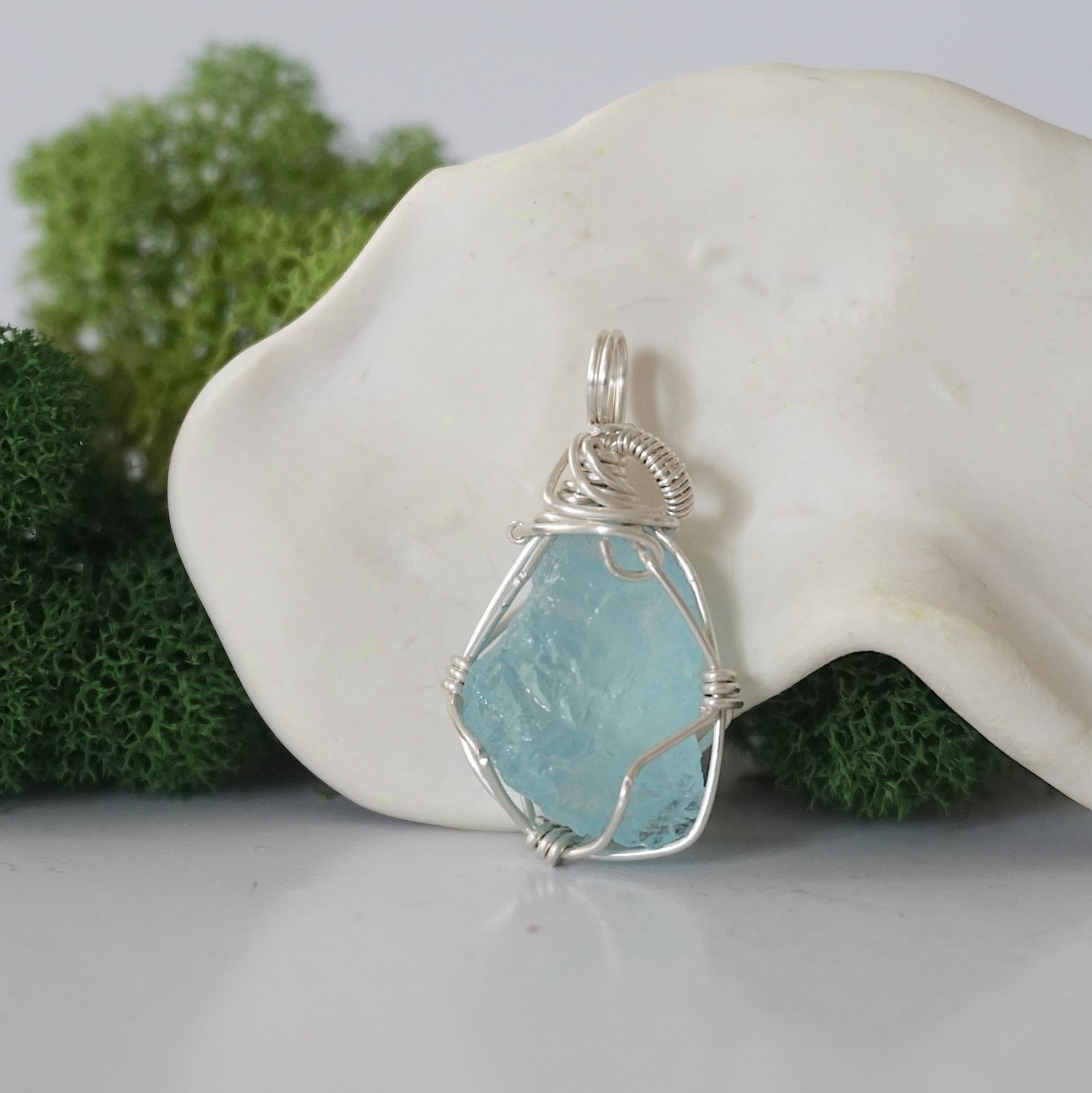 Back view of raw aquamarine wire wrapped pendant — 925 sterling silver hand-wrapped setting, shows craftsmanship and secure stone hold, handmade in Toronto Canada