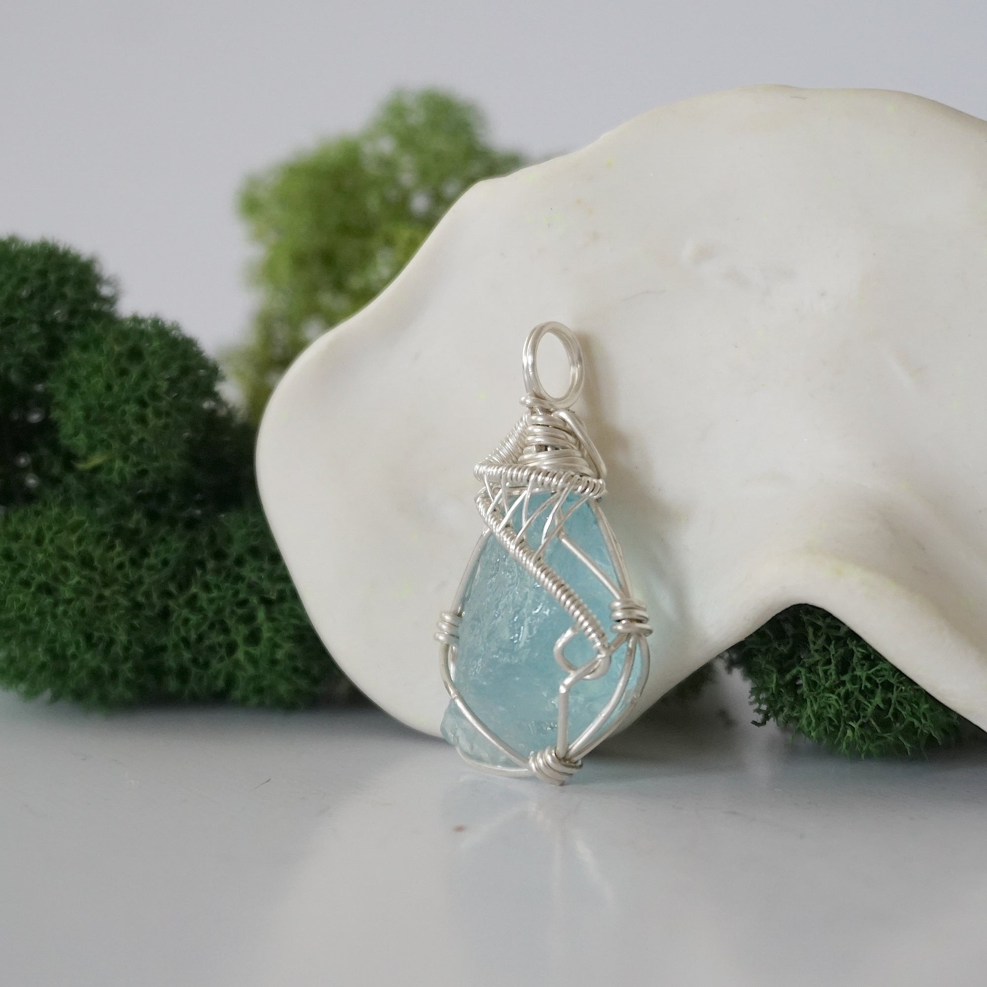 Left side detail of handmade raw aquamarine necklace — artisan wire wrapped 925 sterling silver pendant, natural aquamarine stone, ethically sourced crystal jewelry