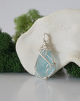 Left side detail of handmade raw aquamarine necklace — artisan wire wrapped 925 sterling silver pendant, natural aquamarine stone, ethically sourced crystal jewelry