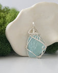 Right side detail of raw aquamarine crystal pendant — intricate 925 sterling silver wire weaving technique, handcrafted artisan wire wrapped jewelry, Designs by Nature Gems