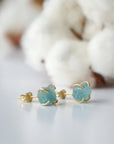 Right side angle of raw aquamarine stud earrings, minimalist gold vermeil claw setting, March birthstone