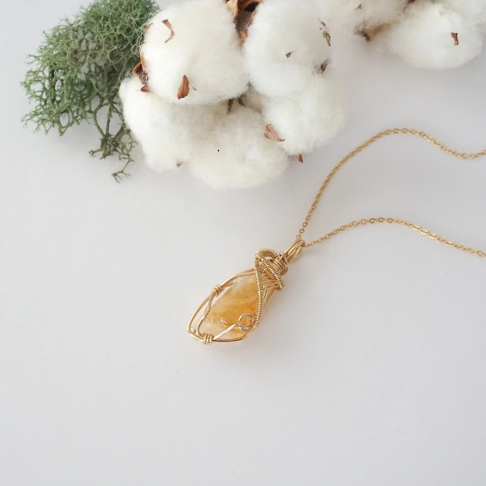 Raw citrine necklace in 14k gold filled laying flat. Handcrafted November birthstone jewelry for women by Designs by Nature Gems.