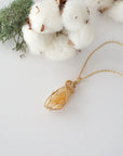 Raw citrine necklace in 14k gold filled laying flat. Handcrafted November birthstone jewelry for women by Designs by Nature Gems.