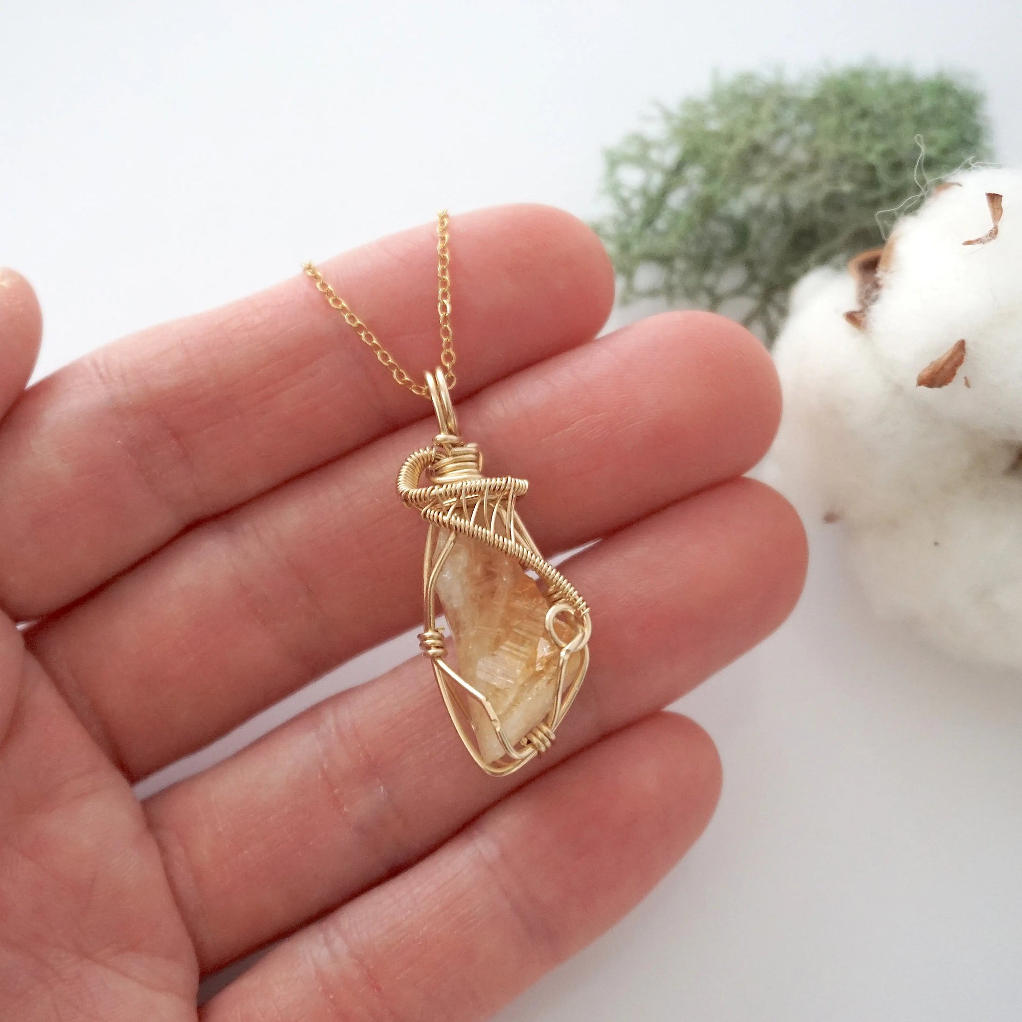 Raw citrine necklace in 14k gold filled shown in hand for size reference. Artisan November birthstone pendant by Designs by Nature Gems.