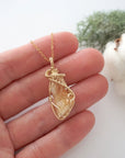 Raw citrine necklace in 14k gold filled shown in hand for size reference. Artisan November birthstone pendant by Designs by Nature Gems.