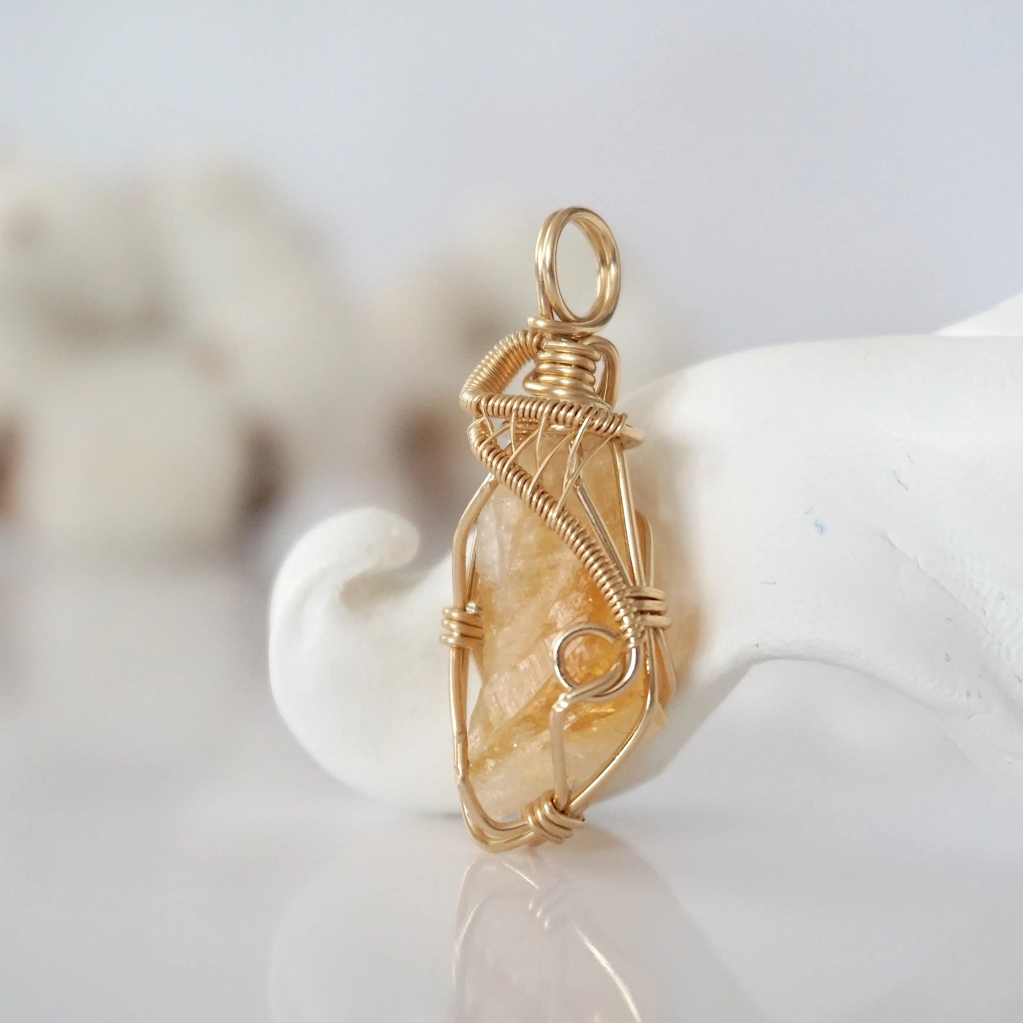 Side view of raw citrine pendant in 14k gold filled, showing artisan wire wrapping. Handcrafted November birthstone necklace by Designs by Nature Gems.