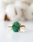Front detail of raw emerald adjustable ring in gold vermeil showing natural emerald stone and artisan setting