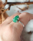 Natural raw emerald ring in sterling silver on female hand, adjustable artisan gemstone ring for women