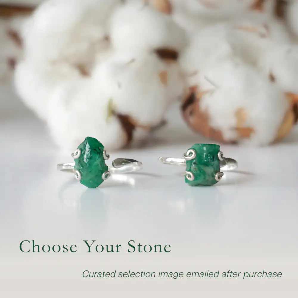Two raw emerald adjustable rings in sterling silver showing natural variation in emerald size, shape, and green colour