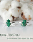 Two raw emerald adjustable rings in sterling silver showing natural variation in emerald size, shape, and green colour