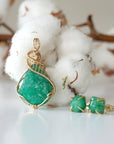 Detailed front view of raw emerald necklace pendant in 14k gold filled. Unique wire wrapped May birthstone necklace by Designs by Nature Gems.