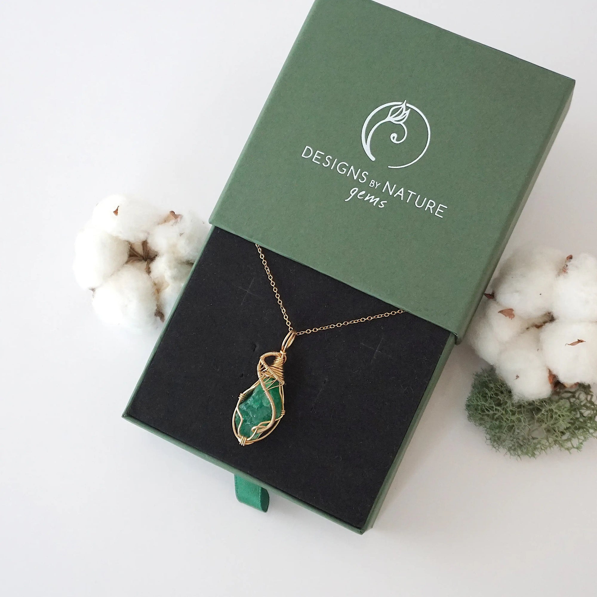 Raw emerald necklace in 14k gold filled displayed in branded Designs by Nature Gems jewelry box. Artisan May birthstone gift for women.