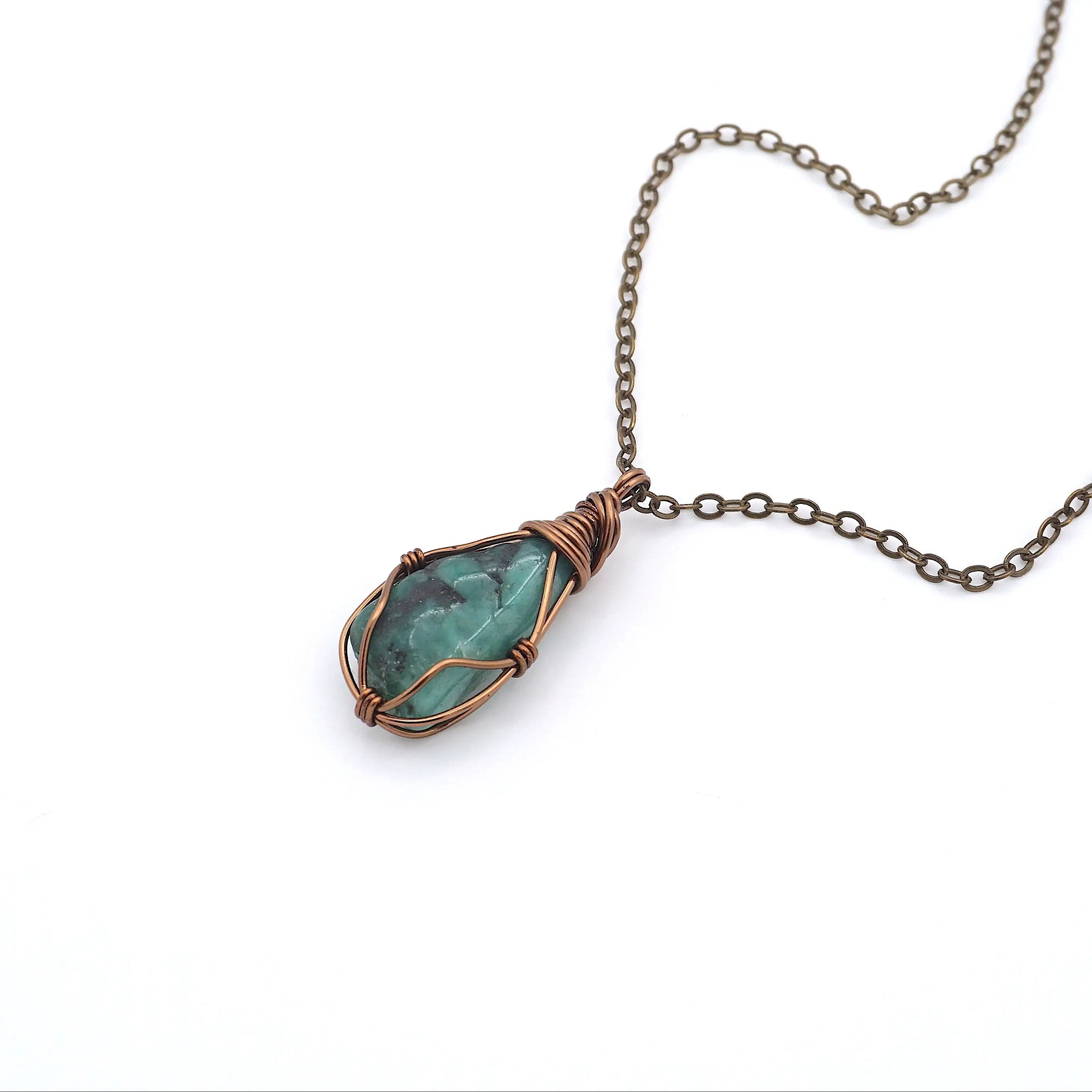 Raw emerald necklace in antique bronze copper wire wrapping by Designs by Nature Gems, handcrafted May birthstone pendant for all genders.