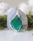 Back angle detail of raw emerald pendant necklace for women with natural emerald and handcrafted sterling silver wrapping