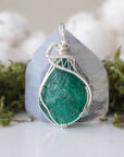 Detailed front view of raw emerald necklace for women with natural emerald and handcrafted 925 sterling silver wire wrapping