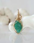 Back view of raw emerald pendant in 14k gold filled, highlighting stone and wire detail. One of a kind May birthstone jewelry by Designs by Nature Gems.