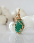 Detailed front view of raw emerald pendant in 14k gold filled. Unique wire wrapped May birthstone jewelry by Designs by Nature Gems.