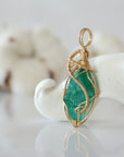 Side view of raw emerald pendant in 14k gold filled, showing artisan wire wrapping. Handcrafted May birthstone necklace by Designs by Nature Gems.