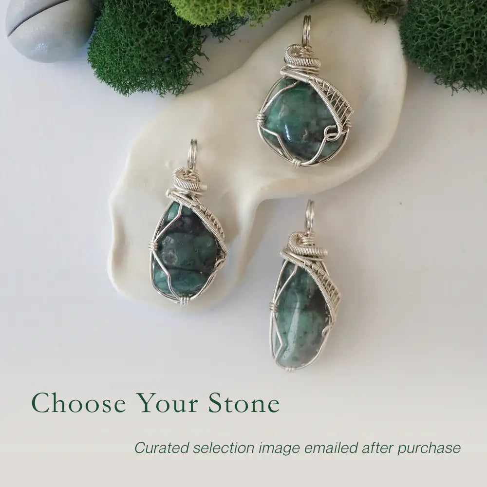 Three raw emerald pendants showing natural variation in size, shape, and green colour by Designs by Nature Gems.
