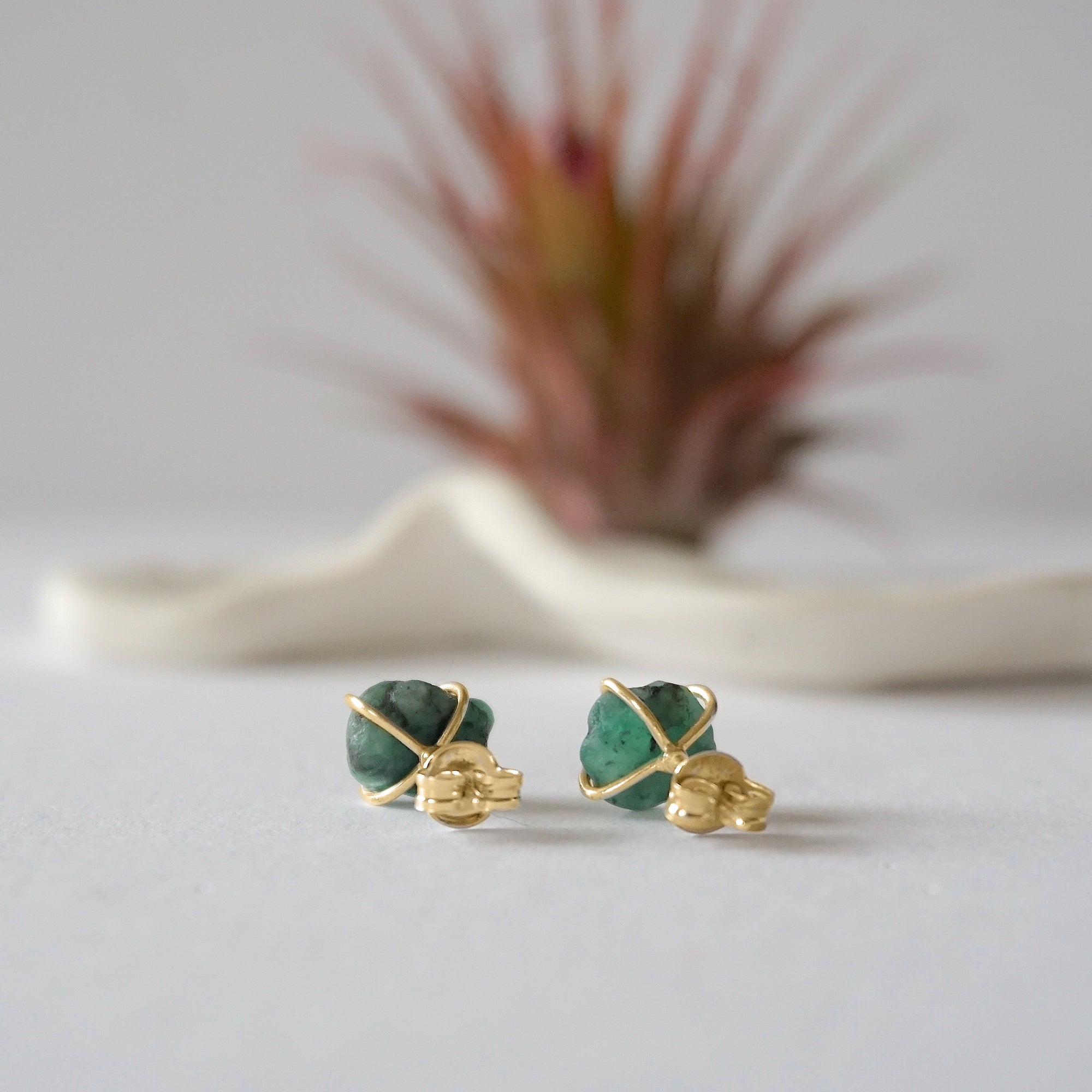 Back view of raw emerald stud earrings in 14k gold vermeil showing artisan setting and earring post detail