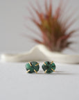 Front view of raw emerald stud earrings in 14k gold vermeil with natural emerald stones and handcrafted prong setting