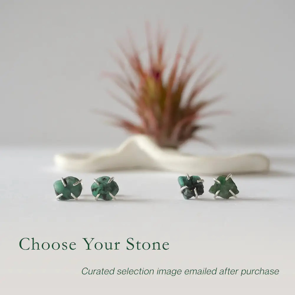 Two pairs of raw emerald stud earrings in sterling silver showing natural variation in emerald shape size and green colour