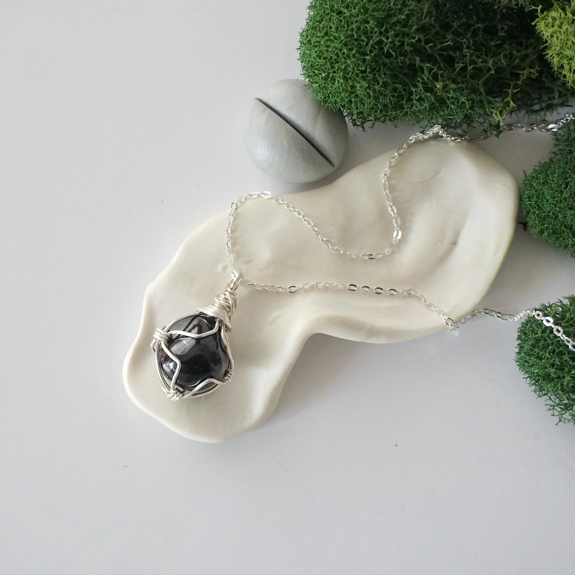 Simple raw garnet necklace with silver plated brass chain laying flat