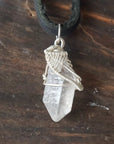 Detailed view of raw Herkimer diamond necklace for men with artisan wire wrapping in 925 sterling silver.