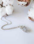 Detailed view of raw Herkimer diamond pendant on 925 sterling silver chain for women with handmade artisan wrapping.