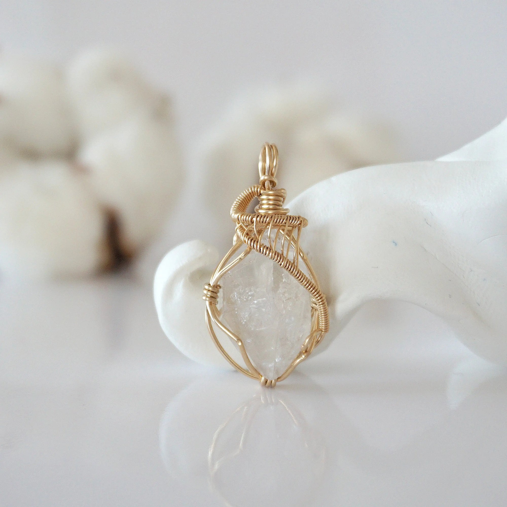 Detailed front view of raw Herkimer diamond pendant in 14k gold filled. Unique wire wrapped April birthstone jewelry by Designs by Nature Gems.