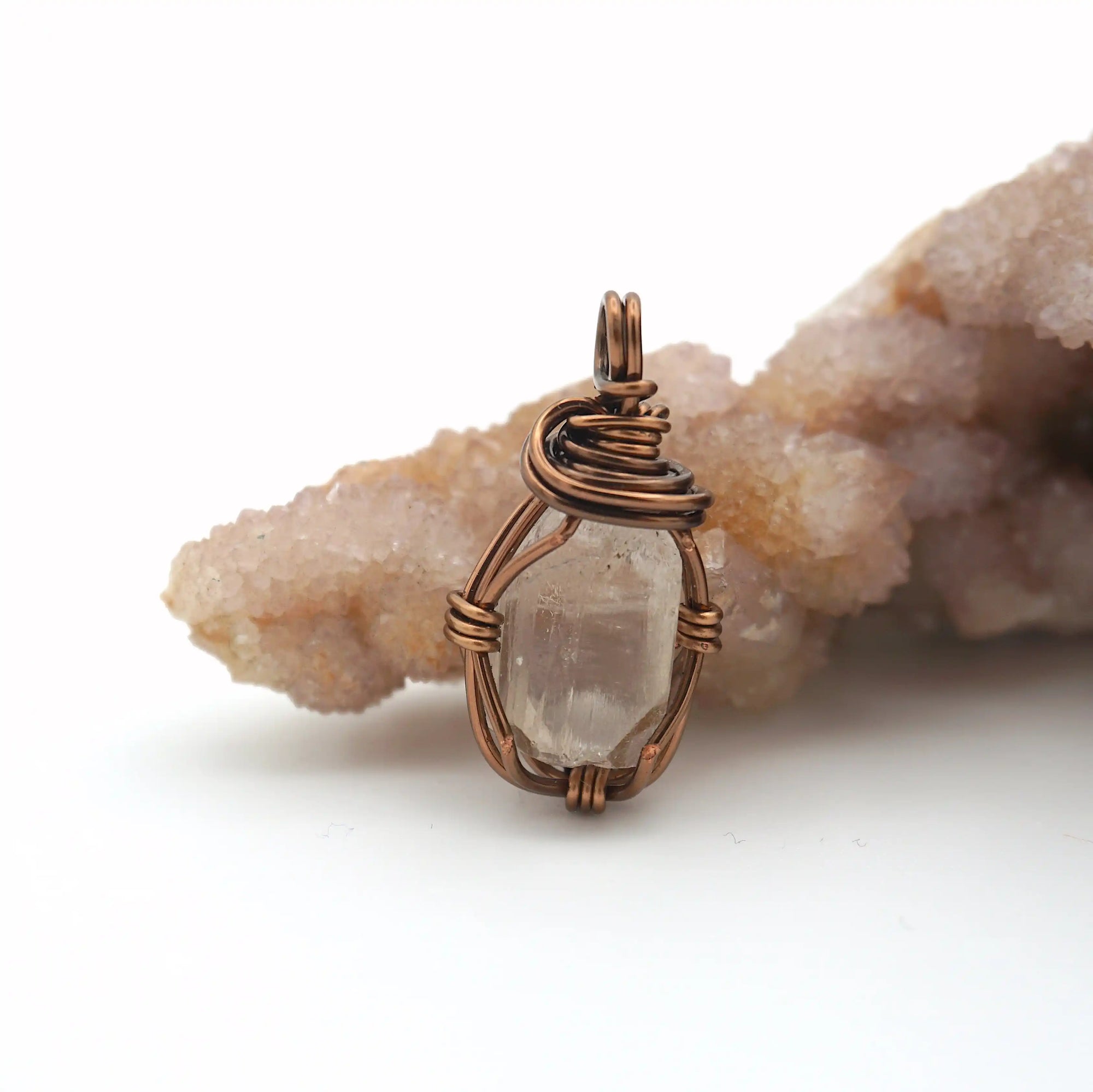 Front angle view of raw Herkimer diamond pendant necklace in antique bronze copper with handcrafted artisan wire wrapping.
