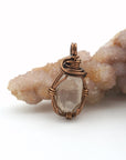 Front angle view of raw Herkimer diamond pendant necklace in antique bronze copper with handcrafted artisan wire wrapping.