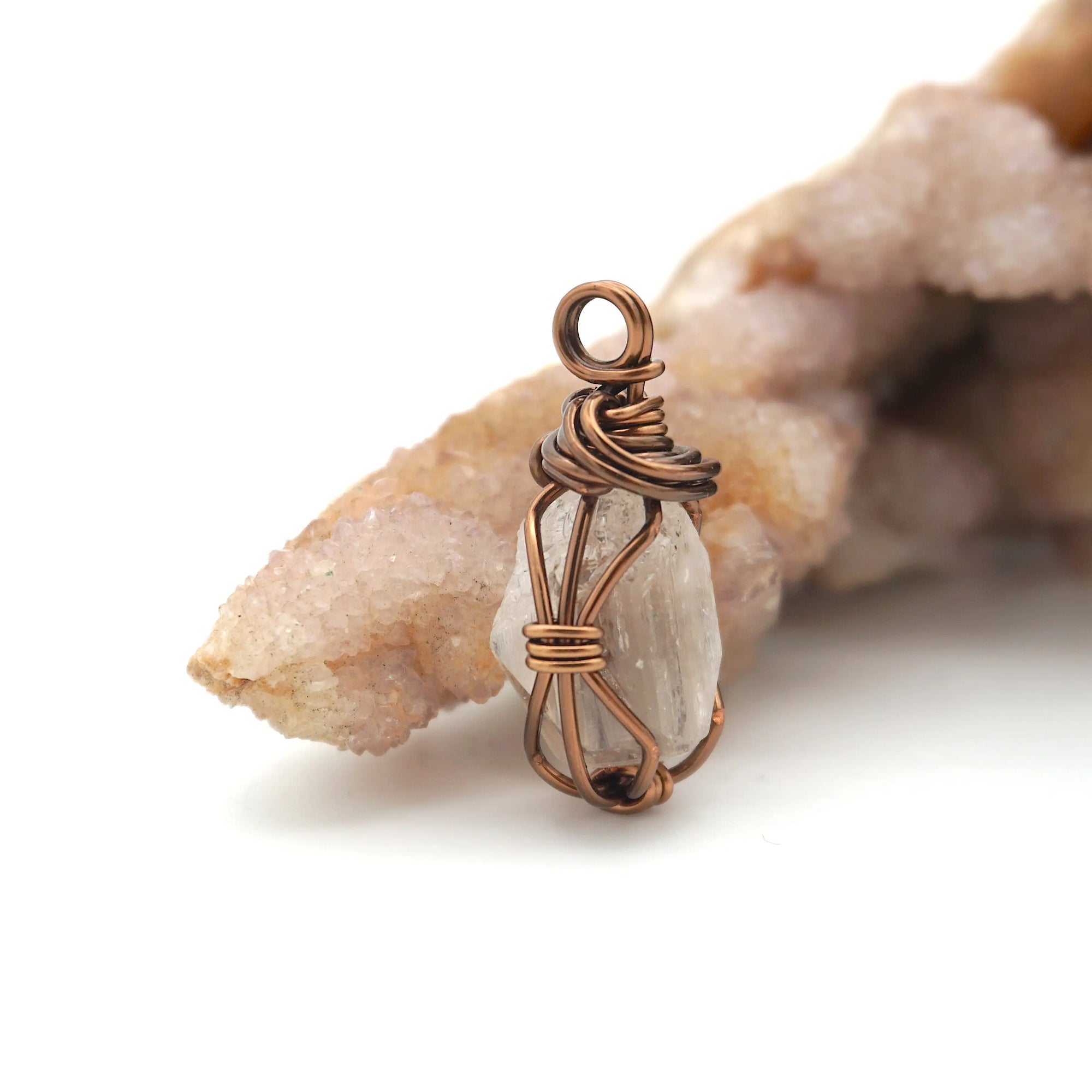 Right angle detail of raw Herkimer diamond pendant showing artisan wire wrapping in antique bronze copper.