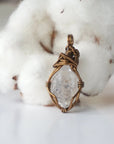 Back view of raw Herkimer diamond pendant for women with handcrafted antique bronze copper wire wrapping.