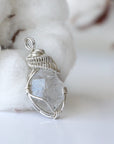 Right angle view of handmade Herkimer diamond pendant for women showing 925 sterling silver wire artistry.
