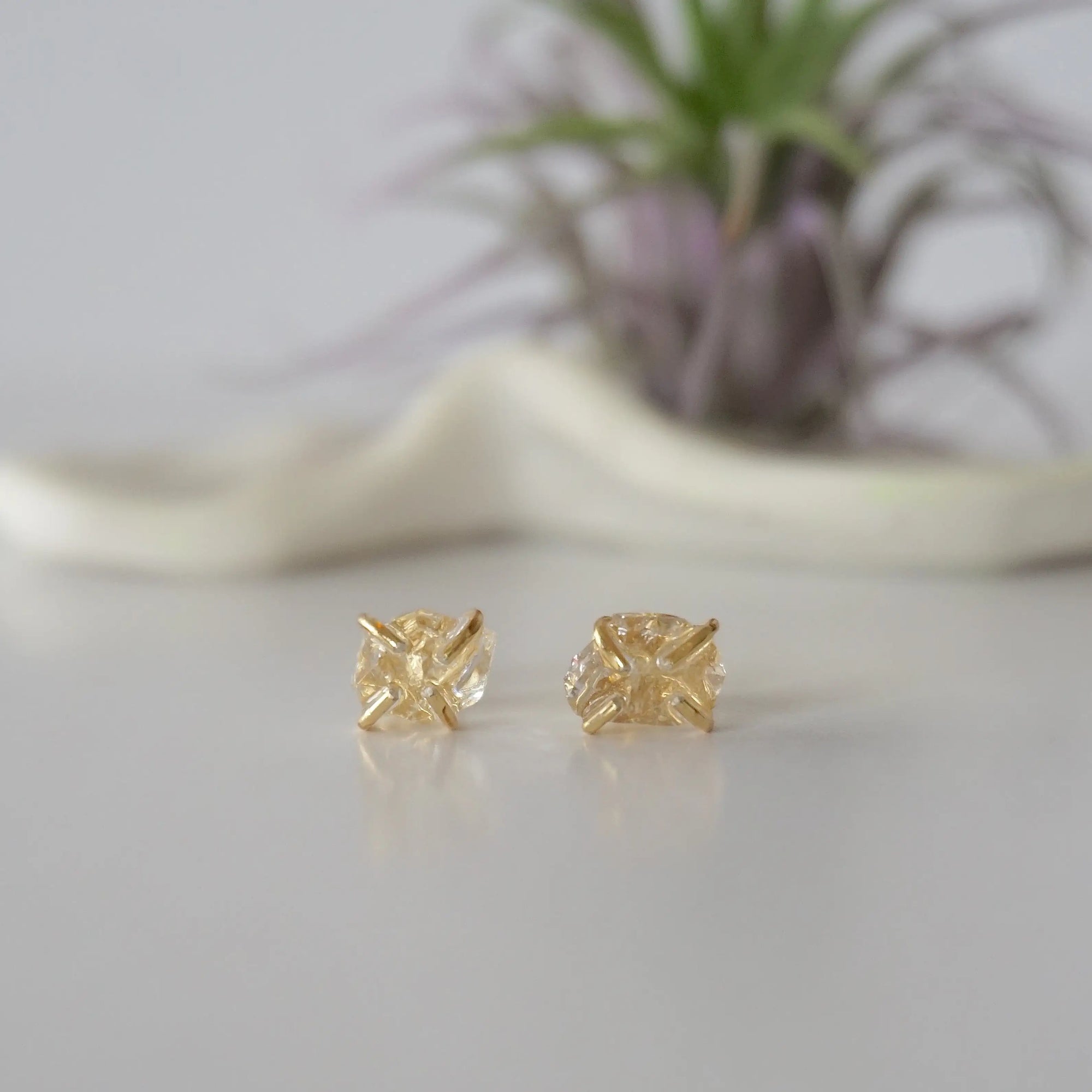 Front view of raw Herkimer diamond stud earrings with minimalist 14k gold vermeil prong setting.