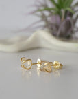 Left side angle view of raw Herkimer diamond stud earrings showing 14k gold vermeil prong setting detail.
