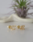 Right side angle view of raw Herkimer diamond stud earrings highlighting 14k gold vermeil prong setting.