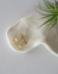 Top view of raw Herkimer diamond stud earrings in 14k gold vermeil with natural crystal shape.