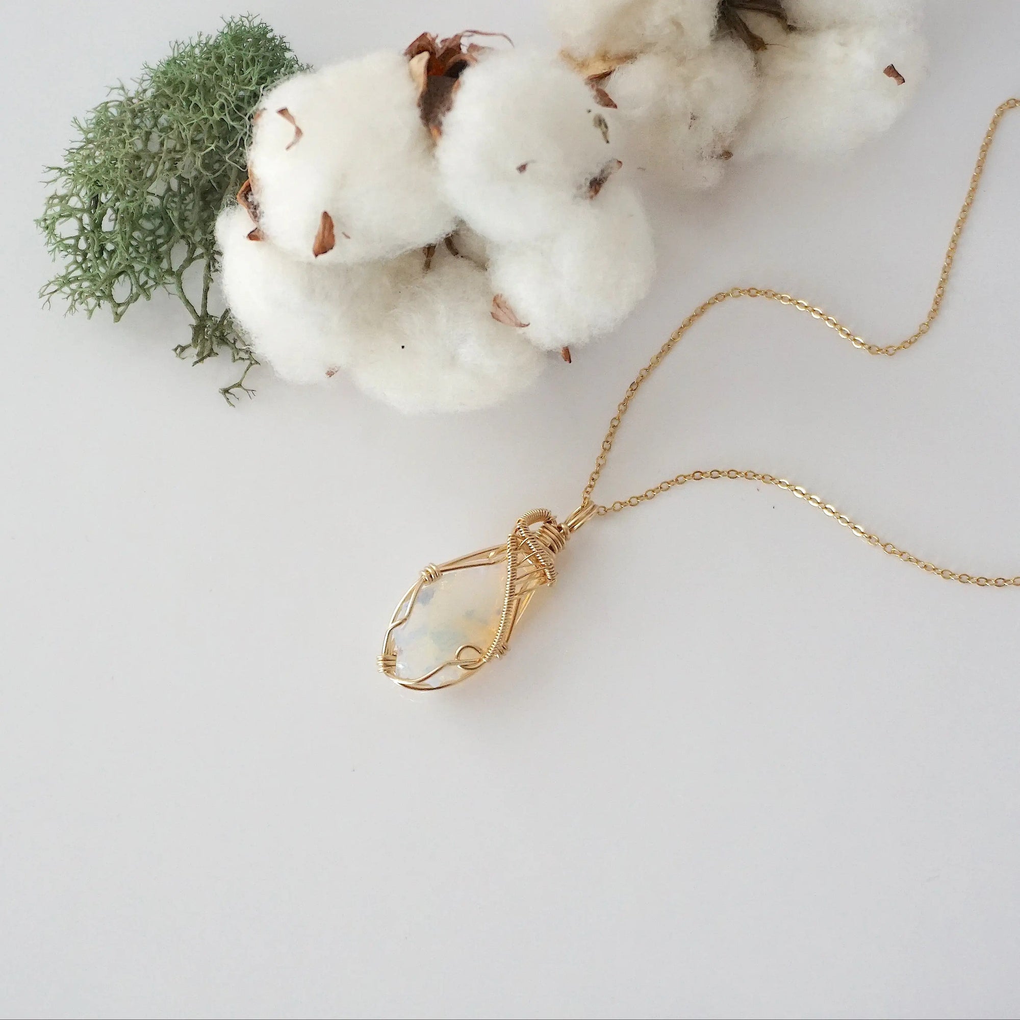 Raw opal necklace in 14k gold filled laying flat. Handcrafted October birthstone jewelry for women by Designs by Nature Gems.