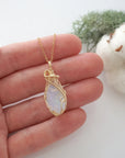 Raw opal necklace in 14k gold filled shown in hand for size reference. Artisan October birthstone pendant by Designs by Nature Gems.