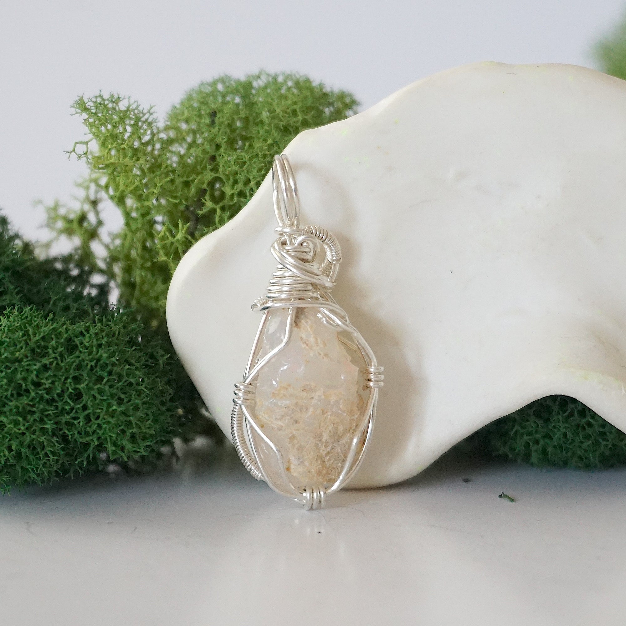 Back view of raw opal wire wrapped pendant — 925 sterling silver hand-wrapped setting, shows craftsmanship and secure stone hold, handmade in Toronto Canada